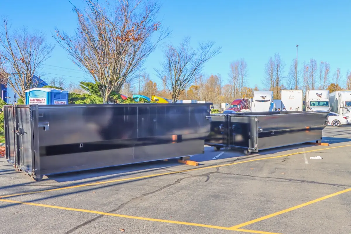 Professional dumpster rental service with roll-off container on residential driveway in Seward